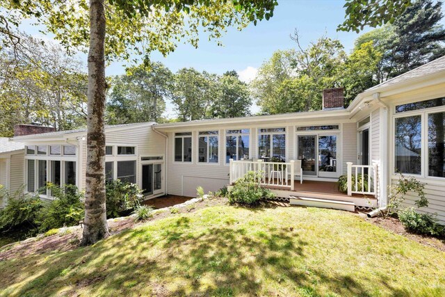 67 Redwood Cir, Mashpee, MA 02649 - rear view of house featuring a chimney, a yard, and a wooden deck