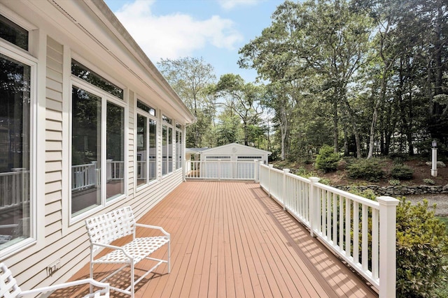 deck featuring an outbuilding and a garage