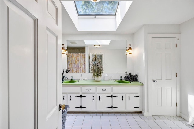 bathroom with vanity, tile patterned floors, and a skylight