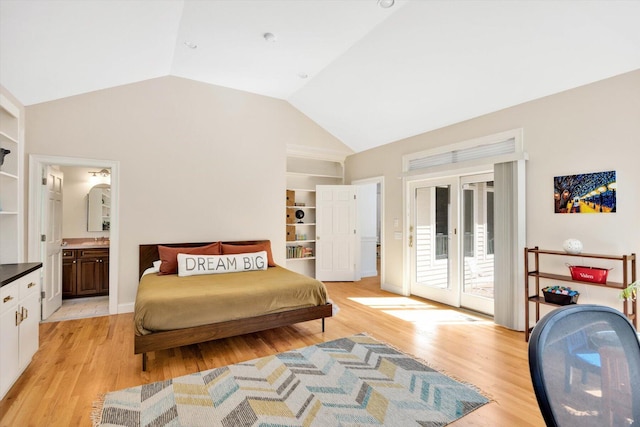 bedroom with lofted ceiling, access to exterior, connected bathroom, and light hardwood / wood-style floors