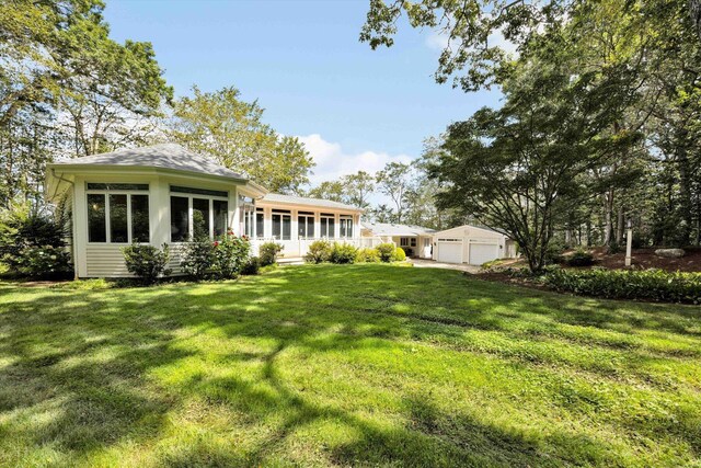 67 Redwood Cir, Mashpee, MA 02649 - back of house featuring a detached garage and a lawn