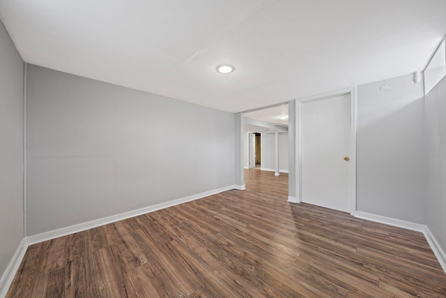 unfurnished room featuring baseboards, recessed lighting, and wood finished floors