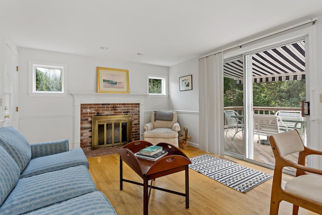 24 Greenland Cir, Yarmouth Port, MA 02675 - living room featuring plenty of natural light, light wood-type flooring, and a fireplace