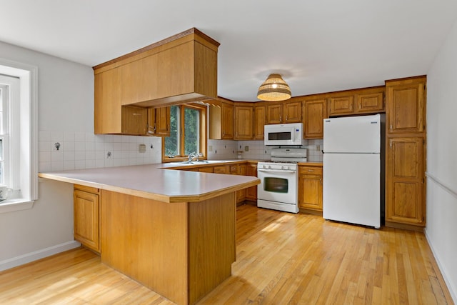 24 Greenland Cir, Yarmouth Port, MA 02675 - kitchen with white appliances, a peninsula, light wood finished floors, tasteful backsplash, and light countertops