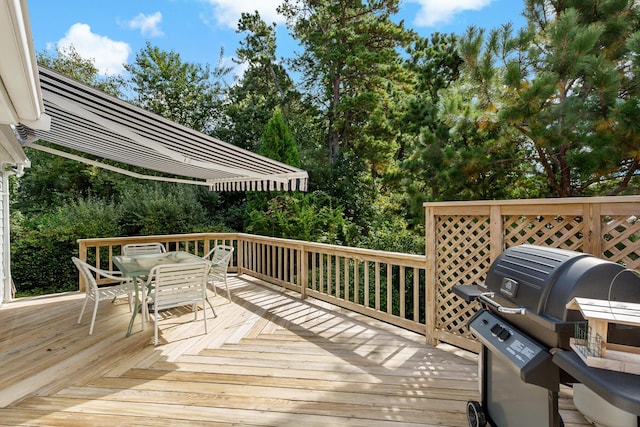 24 Greenland Cir, Yarmouth Port, MA 02675 - wooden deck featuring outdoor dining area, area for grilling, and view of wooded area