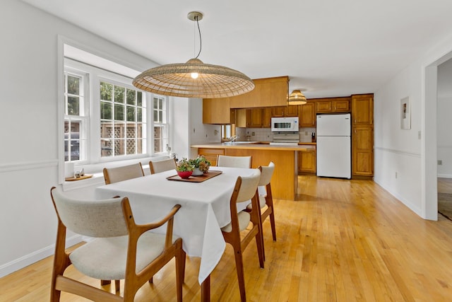 24 Greenland Cir, Yarmouth Port, MA 02675 - dining area featuring light wood-type flooring and baseboards
