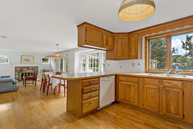 24 Greenland Cir, Yarmouth Port, MA 02675 - kitchen featuring white dishwasher, light wood-style floors, and brown cabinets