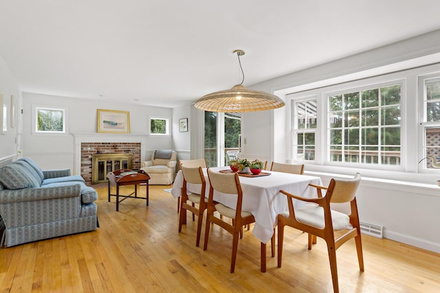24 Greenland Cir, Yarmouth Port, MA 02675 - dining space featuring light wood finished floors and a fireplace
