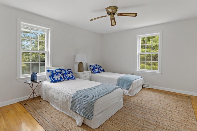 24 Greenland Cir, Yarmouth Port, MA 02675 - bedroom featuring multiple windows, hardwood / wood-style floors, and a ceiling fan