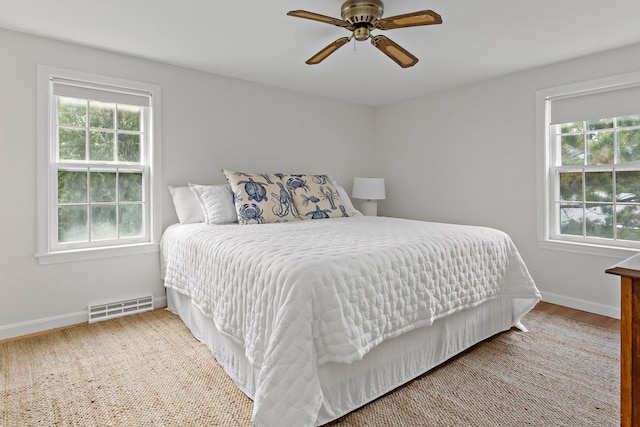 24 Greenland Cir, Yarmouth Port, MA 02675 - bedroom with multiple windows, ceiling fan, and wood finished floors