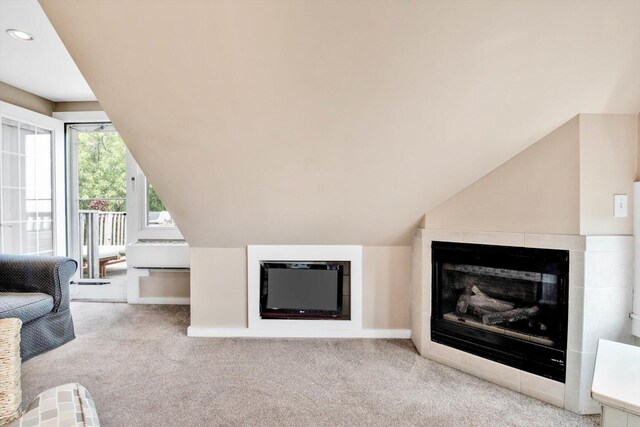 unfurnished living room with light colored carpet and vaulted ceiling