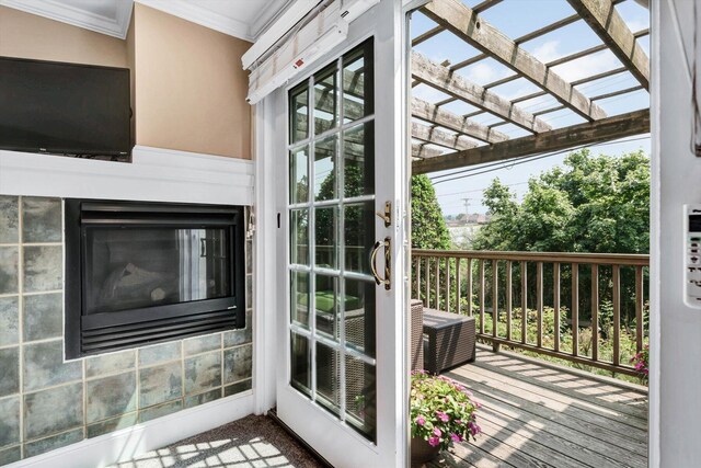 doorway to outside with ornamental molding and a fireplace