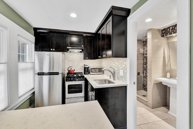 kitchen featuring sink, stainless steel appliances, and light tile patterned flooring