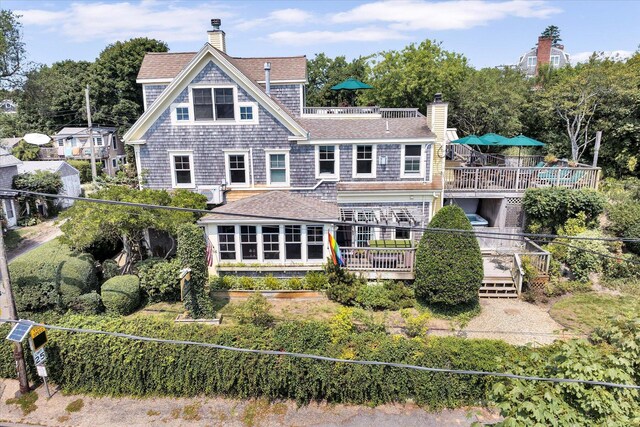 rear view of property featuring a wooden deck