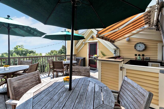 wooden terrace with an outdoor bar