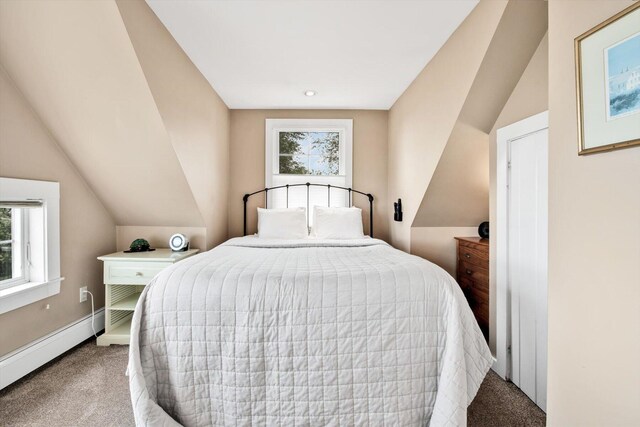 carpeted bedroom featuring baseboard heating and lofted ceiling