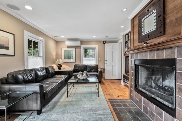 living room with an AC wall unit, dark wood-type flooring, ornamental molding, and a fireplace