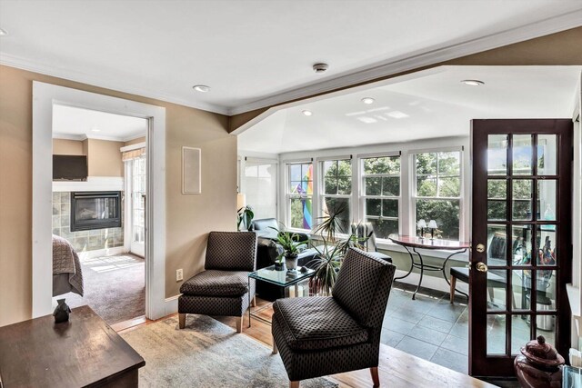 tiled living room with a fireplace and crown molding