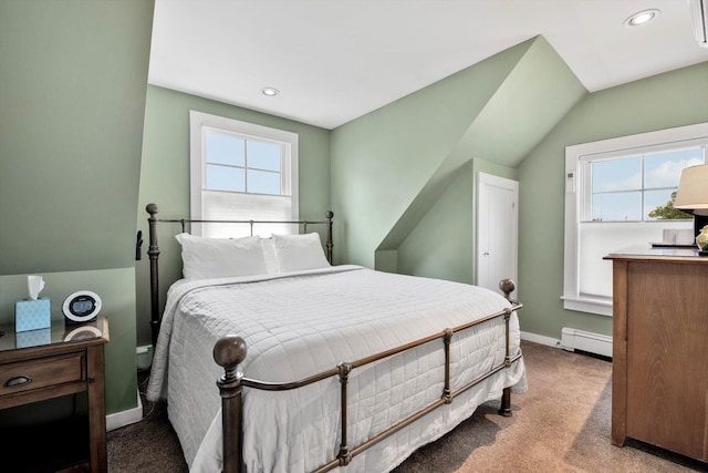 bedroom featuring baseboard heating, multiple windows, light colored carpet, and lofted ceiling