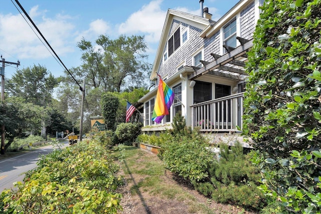 view of property exterior with a pergola