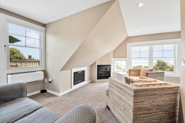 living room with light colored carpet, a wealth of natural light, and lofted ceiling