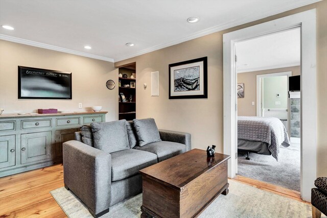 living room with light wood-type flooring and ornamental molding