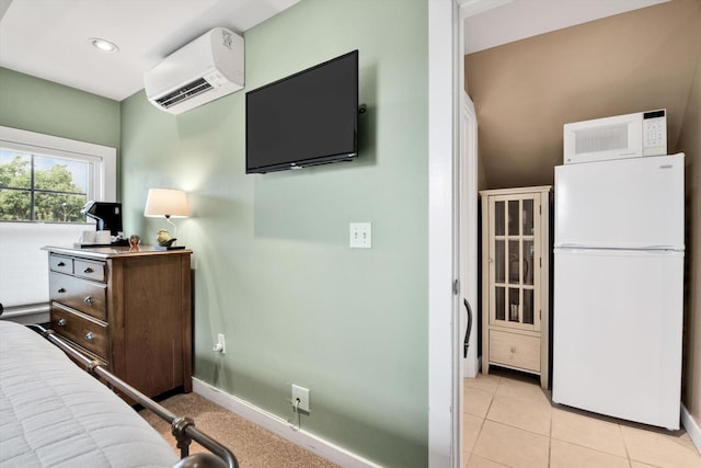 tiled bedroom with a wall mounted AC and white fridge