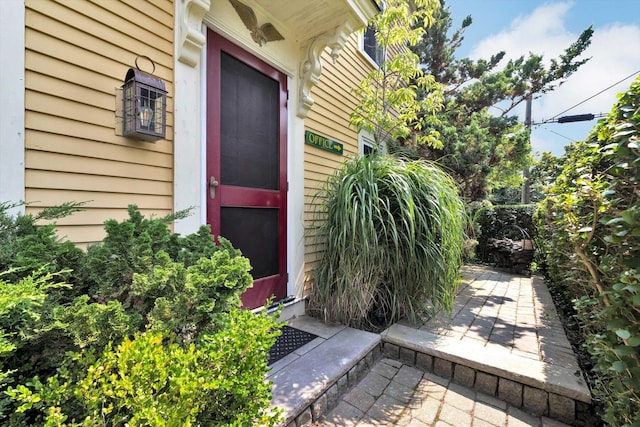 view of exterior entry featuring a patio