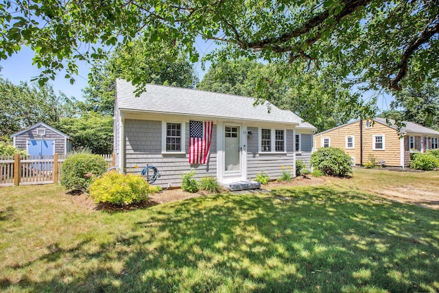 31 Chase St, Dennis Port, MA 02639 - view of front facade featuring an outbuilding, a front yard, and roof with shingles