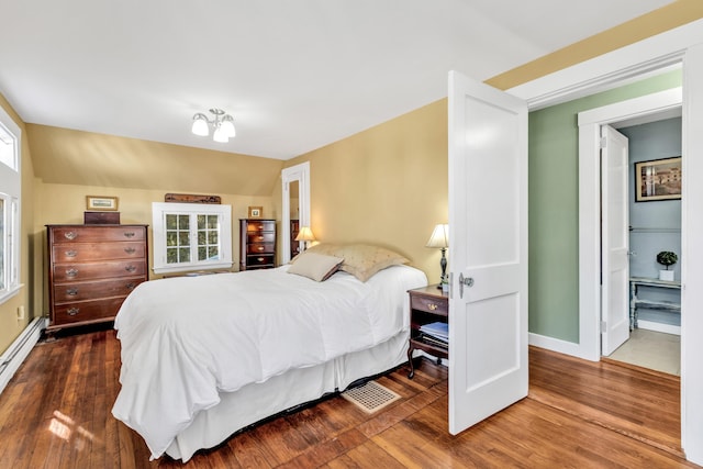 bedroom featuring dark hardwood / wood-style floors, multiple windows, and lofted ceiling