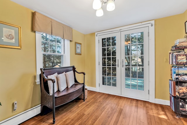 sitting room with light hardwood / wood-style flooring, a baseboard heating unit, and french doors
