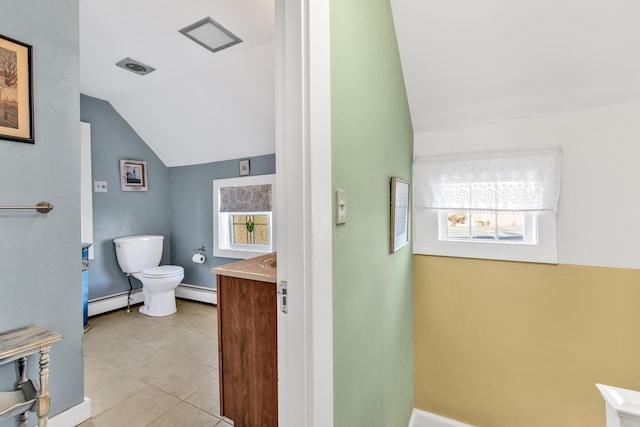 bathroom with toilet, vanity, vaulted ceiling, and baseboard heating