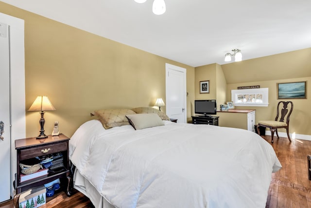 bedroom featuring hardwood / wood-style flooring and lofted ceiling