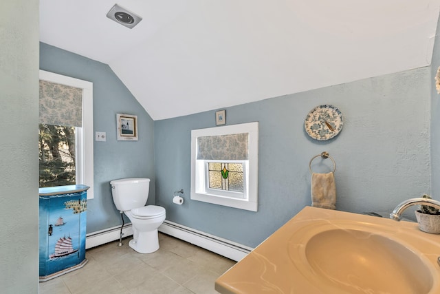 bathroom with a baseboard heating unit, toilet, vaulted ceiling, and vanity