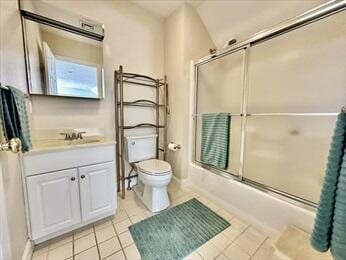 bathroom featuring tile patterned flooring, toilet, shower / bath combination with glass door, vanity, and baseboards