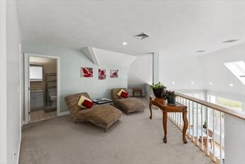 bonus room featuring carpet flooring, visible vents, and baseboards