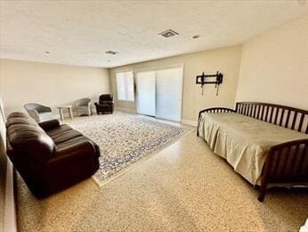 bedroom with visible vents and speckled floor