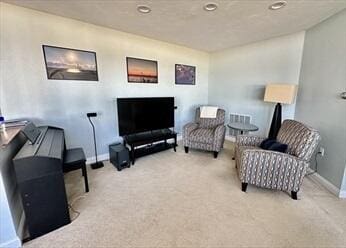 sitting room featuring carpet flooring and baseboards