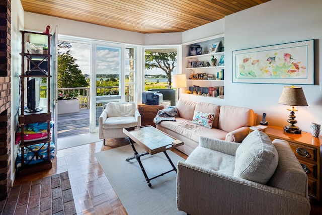 living room with built in shelves and parquet floors