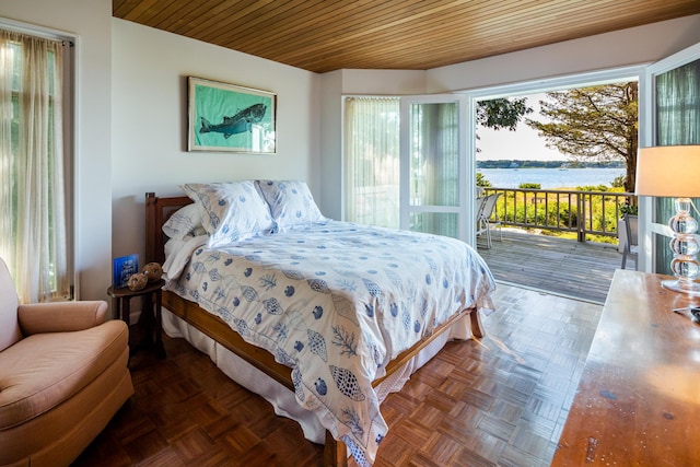 bedroom featuring dark parquet floors, wood ceiling, a water view, and access to outside