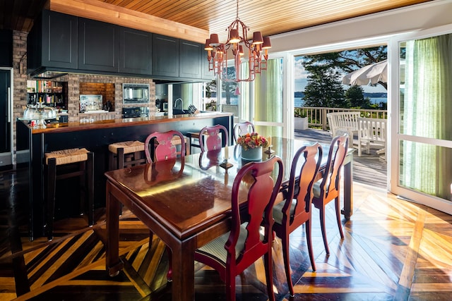 dining area with plenty of natural light, parquet floors, a notable chandelier, and wood ceiling