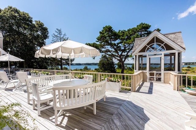 wooden terrace featuring a water view