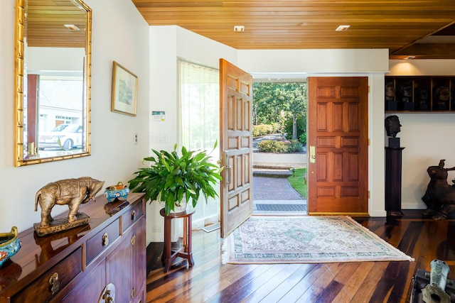 foyer entrance with dark wood-type flooring and wood ceiling