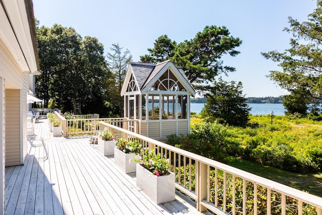 wooden deck featuring a water view