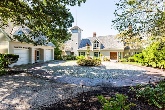 new england style home featuring a garage