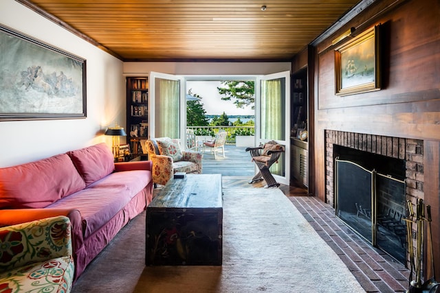 living room with a brick fireplace and ornamental molding