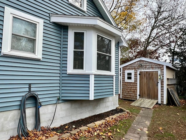 view of property exterior featuring a storage unit