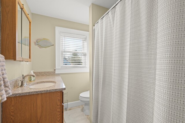 bathroom with vanity, toilet, and tile patterned floors