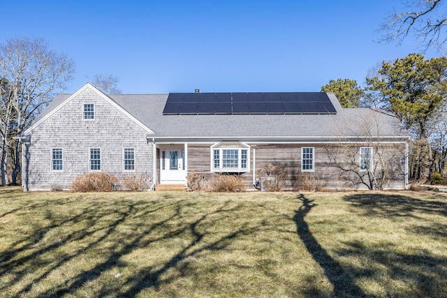 view of front of house with solar panels and a front yard