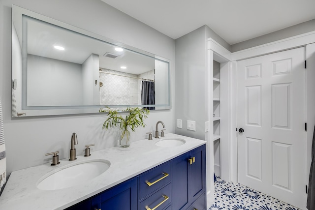 bathroom with double vanity, visible vents, a shower with shower curtain, and a sink